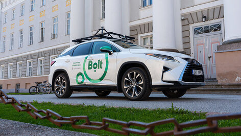 White Lexus with logos of University of Tartu, Autonomous Driving Lab, and Bolt